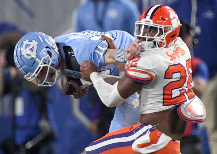 Clemson linebacker Trenton Simpson (22) tackles North Carolina quarterback Drake Maye (10) during the second quarter of the ACC Championship football game at Bank of America Stadium in Charlotte, North Carolina.